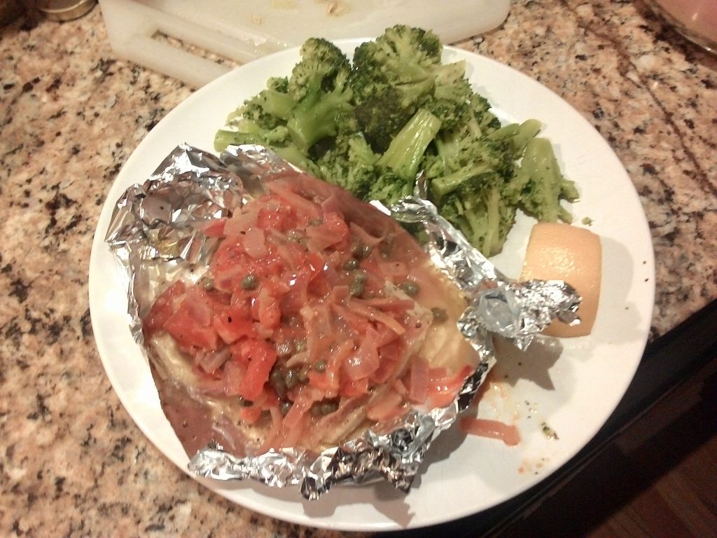 Chicken based with tomatoes, along with broccoli.